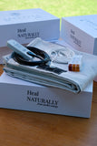 Grounding sheet Sábanas de grounding with connection wires and remote on a wooden table.
